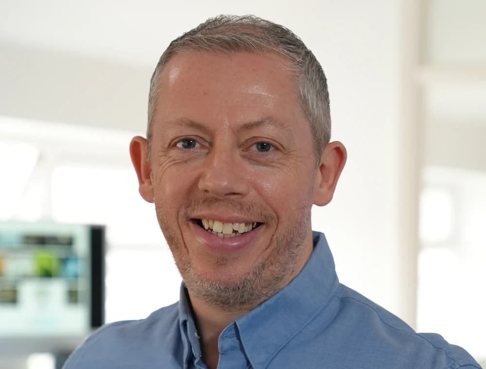 Mark Channon, smiling, in a blue shirt